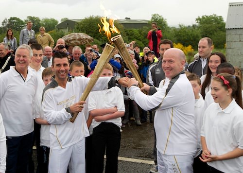 Boxers Wayne McCullough and Michael Carruth pass the Olympic Flame across the border. Picture: Mark Pearce
